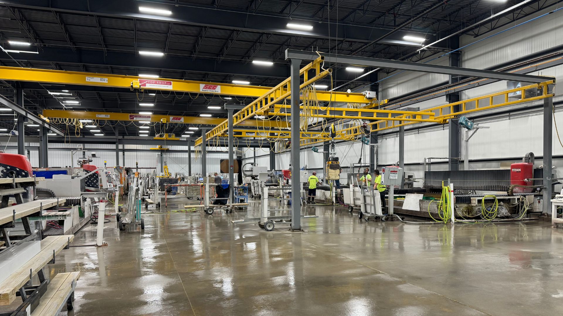 Countertop production shop with overhead cranes, fabrication equipment, and workstations